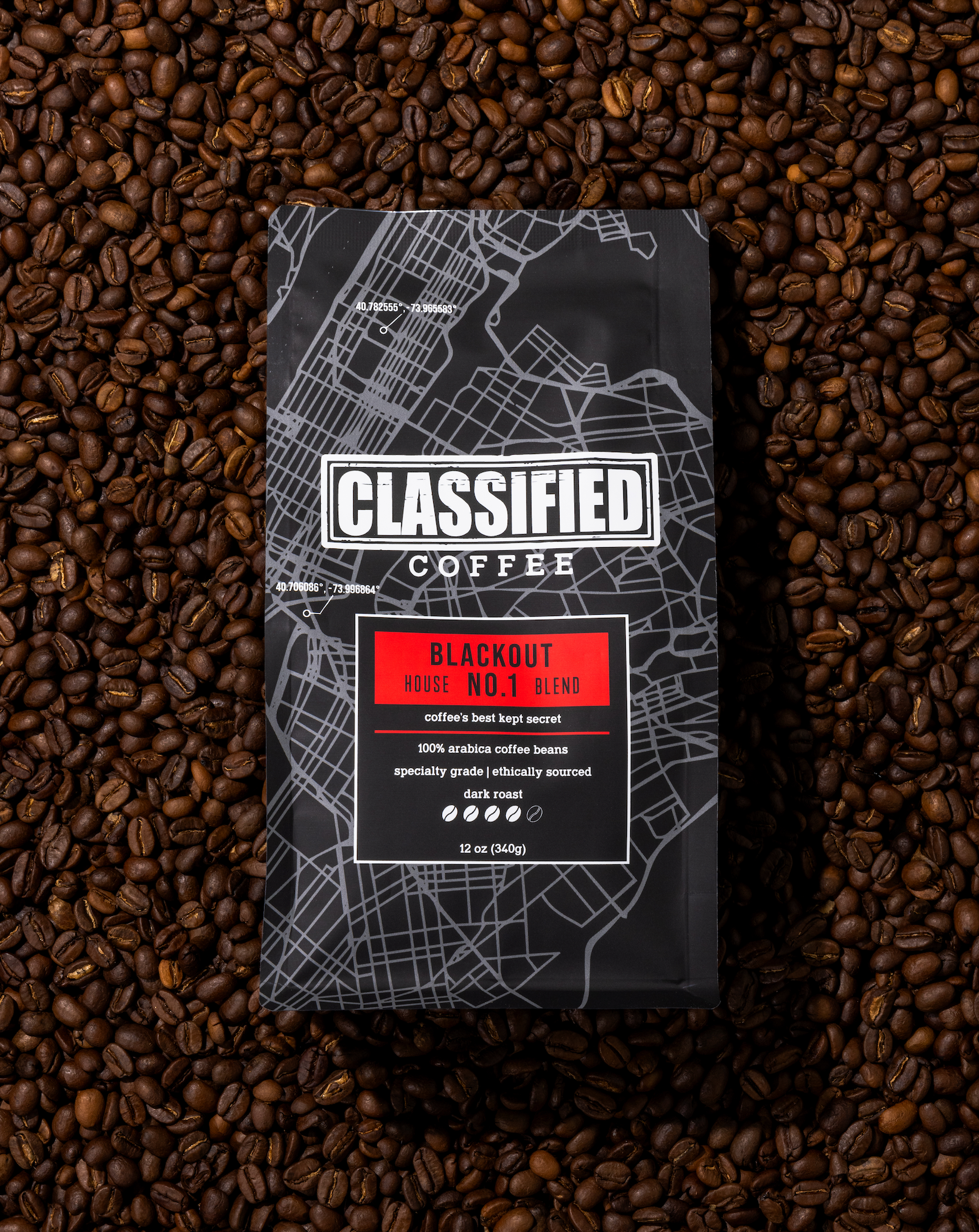 Classified Coffee Co. Blackout Blend coffee bag in a pile of coffee beans